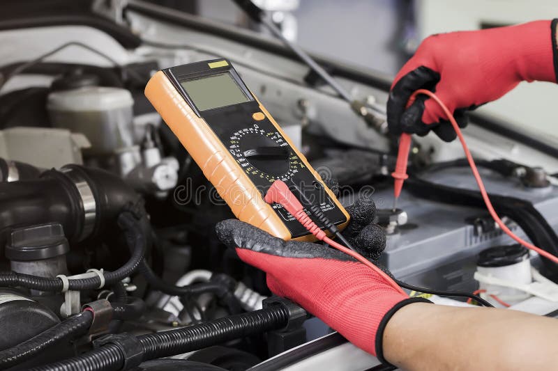 A Technician is Checking the Car Battery for Availability Stock Photo