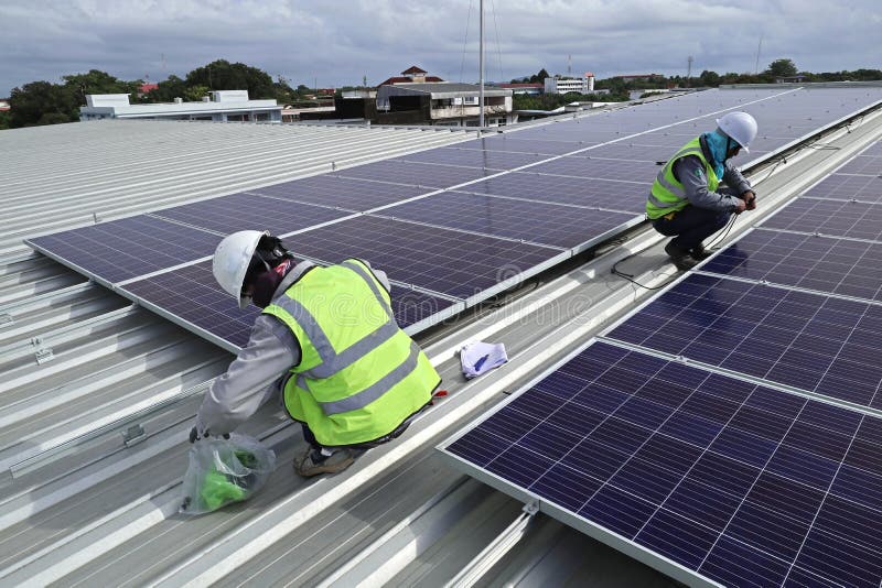 Technician Connecting Cable of Solar Rooftop stock photography