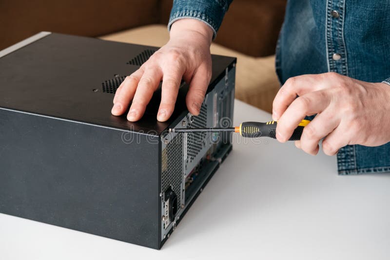 Technician disassemble computer with a screwdriver for problems diagnostic stock photo