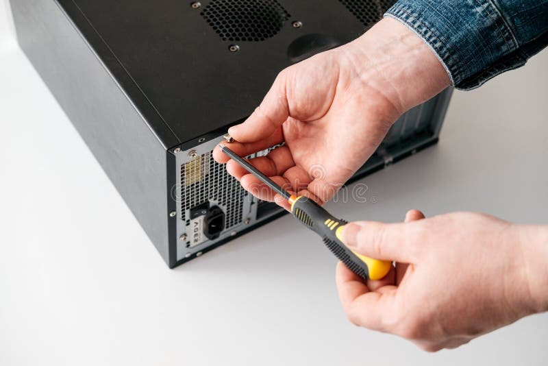 Technician disassemble computer with a screwdriver for problems diagnostic stock images
