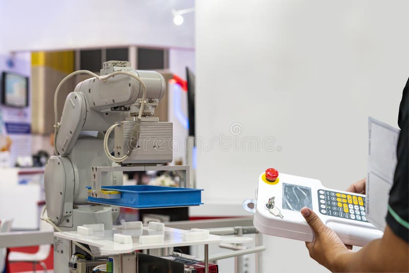 Technician enter command information pass wireless remote for control automatic robot or automation machine to carry box at automation transportation line in manufacturing process at smart factory.