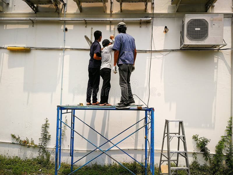 The Technician is Equipped with a Hanging Stand for Air Conditioning. Editorial Photography