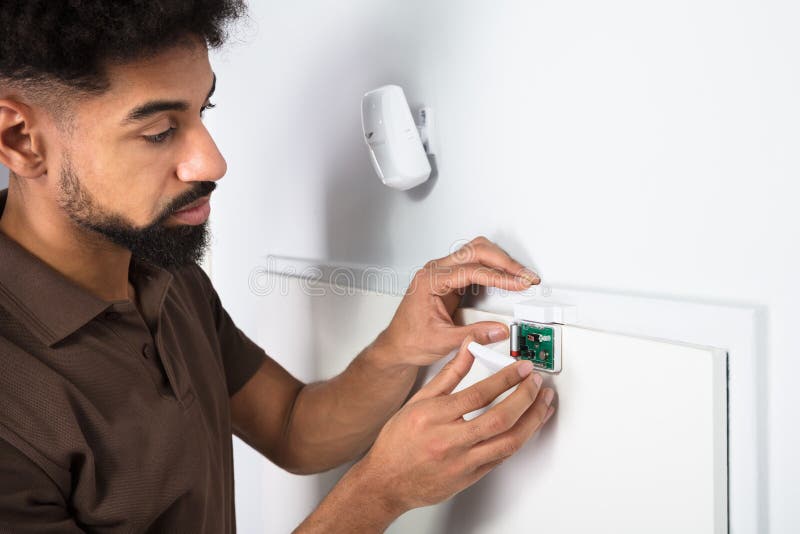 Technician Fixing Security System Door Sensor stock photo