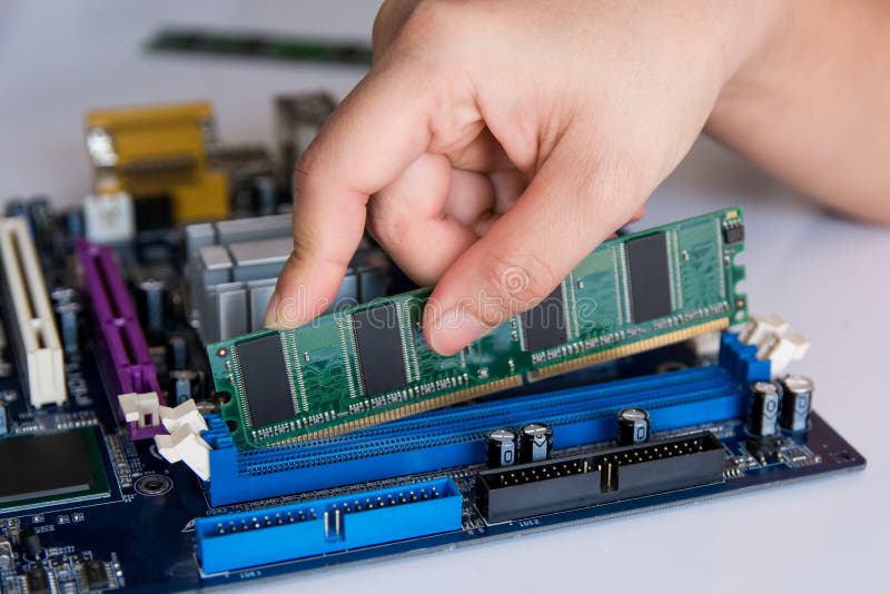 Technician installing RAM stick (random access memory) to socket stock image