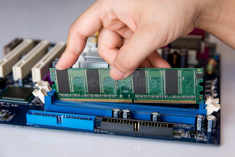 Technician installing RAM stick (random access memory) to socket royalty free stock photo