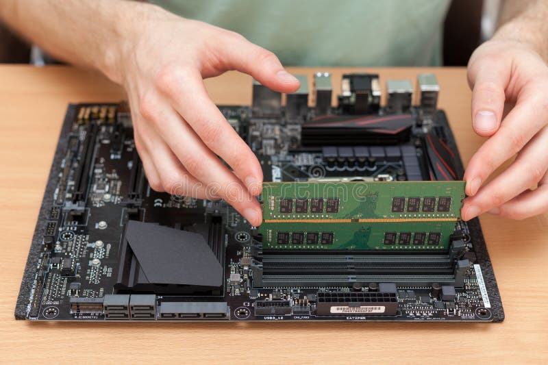 Technician Installing random access memory into PC. stock image