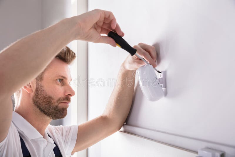 Technician Installing Security System Door Sensor stock photo