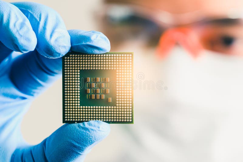The technician looking to the CPU for analyzing in the lab. the concept of computer, service, electronics, hardware, repairing, up royalty free stock photo