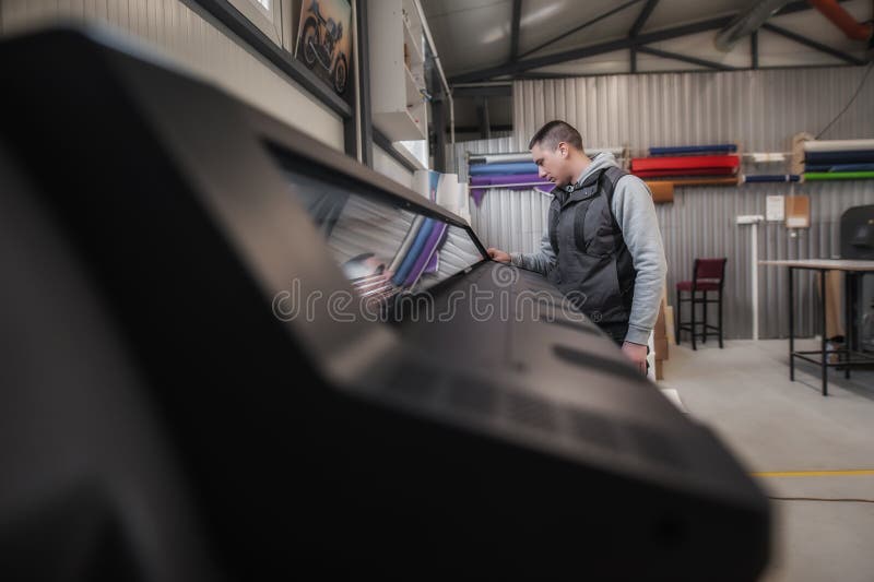 Technician operator checking status on touchscreen front display monitor station stock photo
