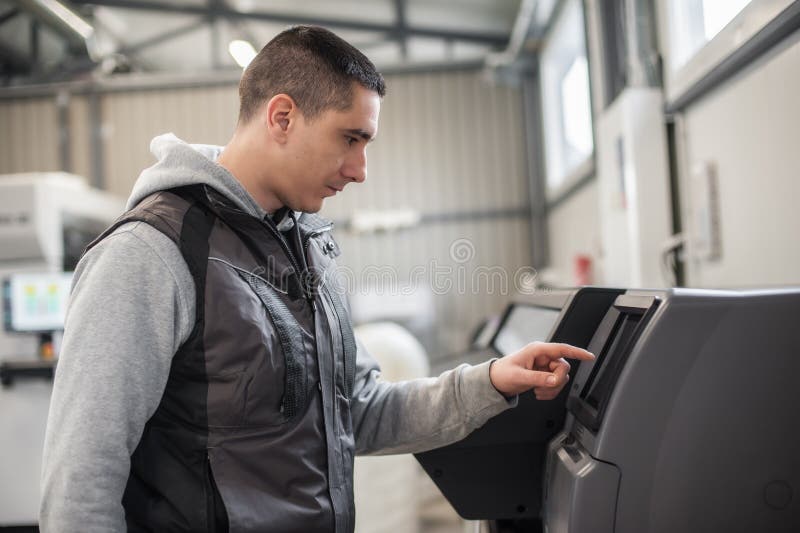 Technician operator checking status on touchscreen front display monitor station stock photo
