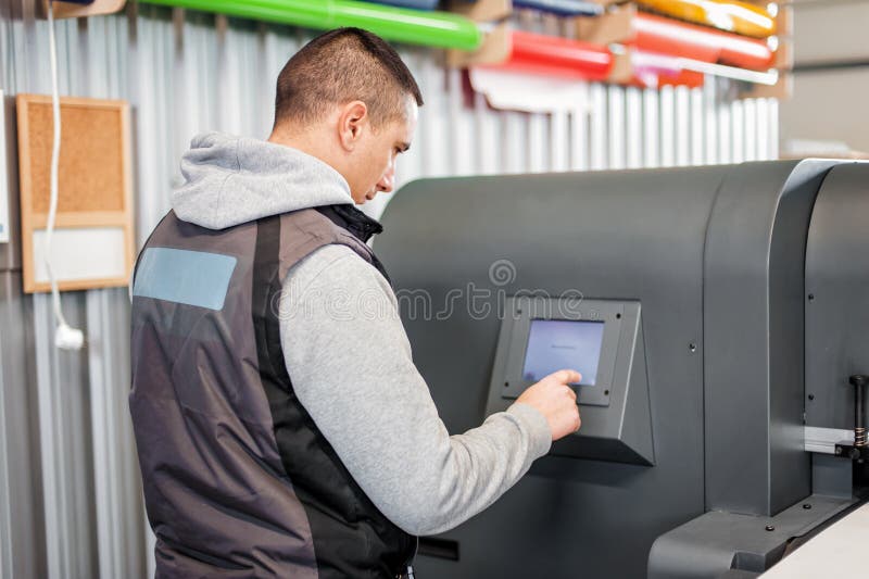 Technician operator checking status on touchscreen front display monitor station stock image
