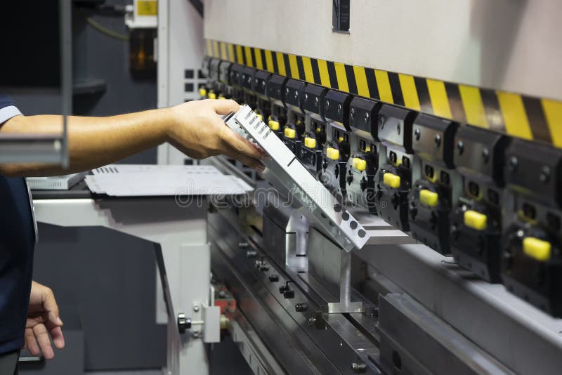 The technician operator use hydraulic bending machine. stock images