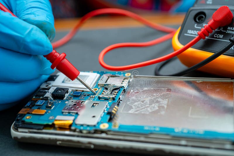 Technician Repairing Inside of Mobile Phone by Soldering Iron