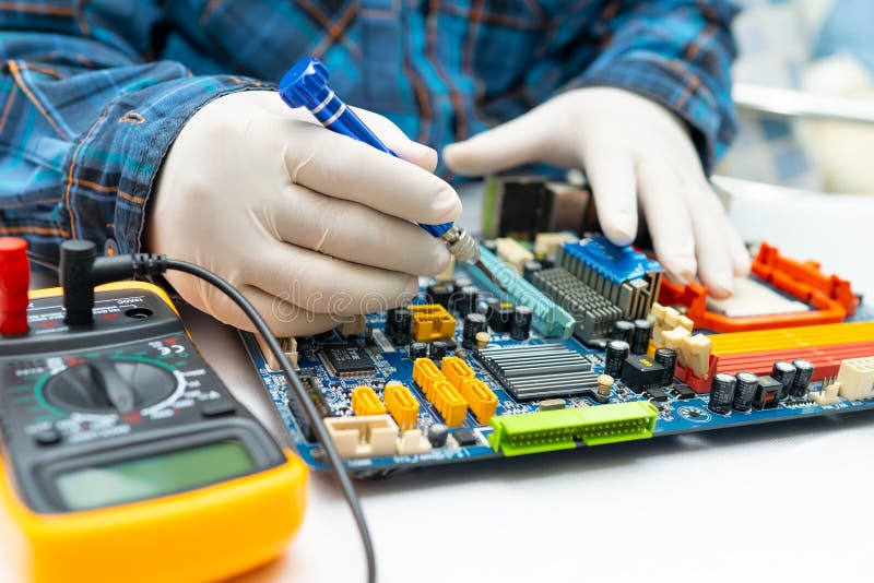 Technician repairing micro circuit main board computer electronic technology, hardware, mobile phone, upgrade, cleaning. royalty free stock photography