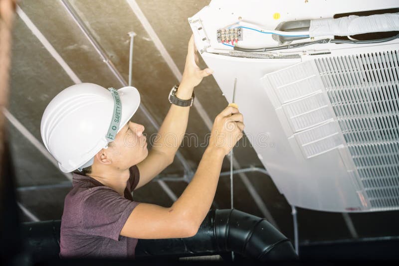 Technician runs the air-conditioning refrigerant from the tank royalty free stock images Technician runs the air-conditioning refrigerant from the tank royalty free stock images