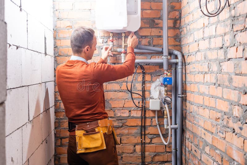 Technician Servicing an Hotwater Heater. Stock Photo Image of repair