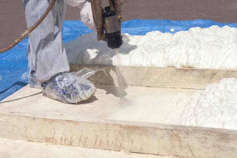 Technician spraying foam insulation using Plural Component Spray Gun. royalty free stock image Technician spraying foam insulation using Plural Component Spray Gun. royalty free stock image