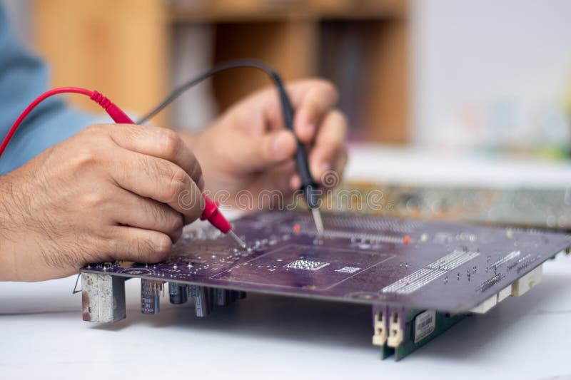 Technician Using Tool To Measure Circuit Board Check and Repair Stock Circuit Diagram