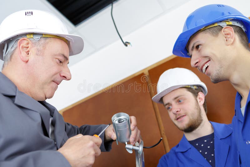Technician Worker Installing Video Surveillance Camera on Wall Stock