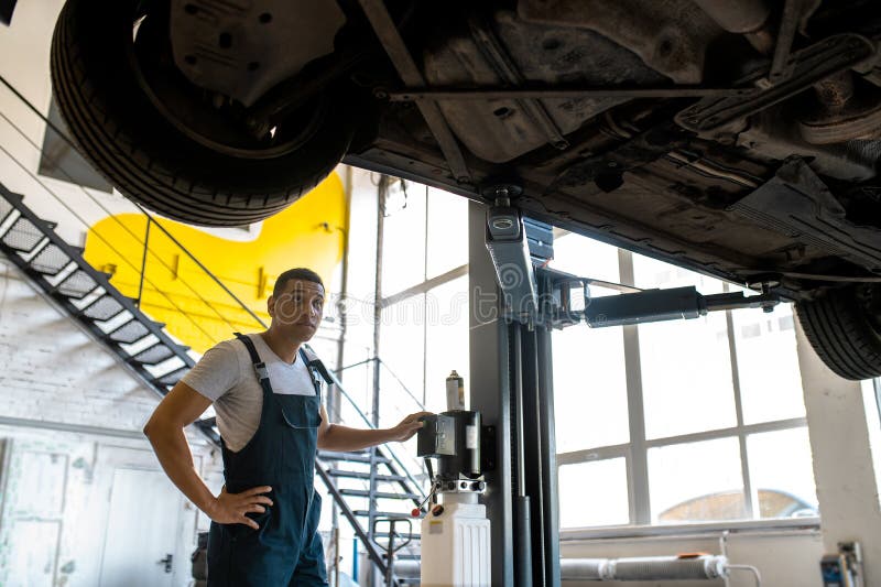 Technicians at Car Service Doing Car Lift for Car Inspection Stock Photo Image of diversity