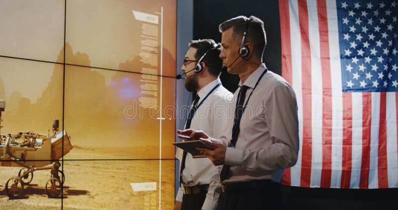 Technicians overviewing Mars landing royalty free stock photography Technicians overviewing Mars landing royalty free stock photography