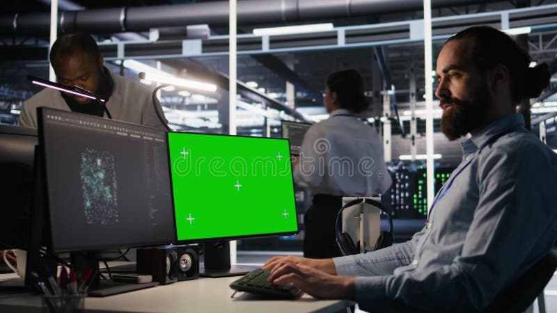 Technicien de centre de données effectuant des mises à jour logicielles à l'aide d'un ordinateur de simulation à écran vert banque de vidéos