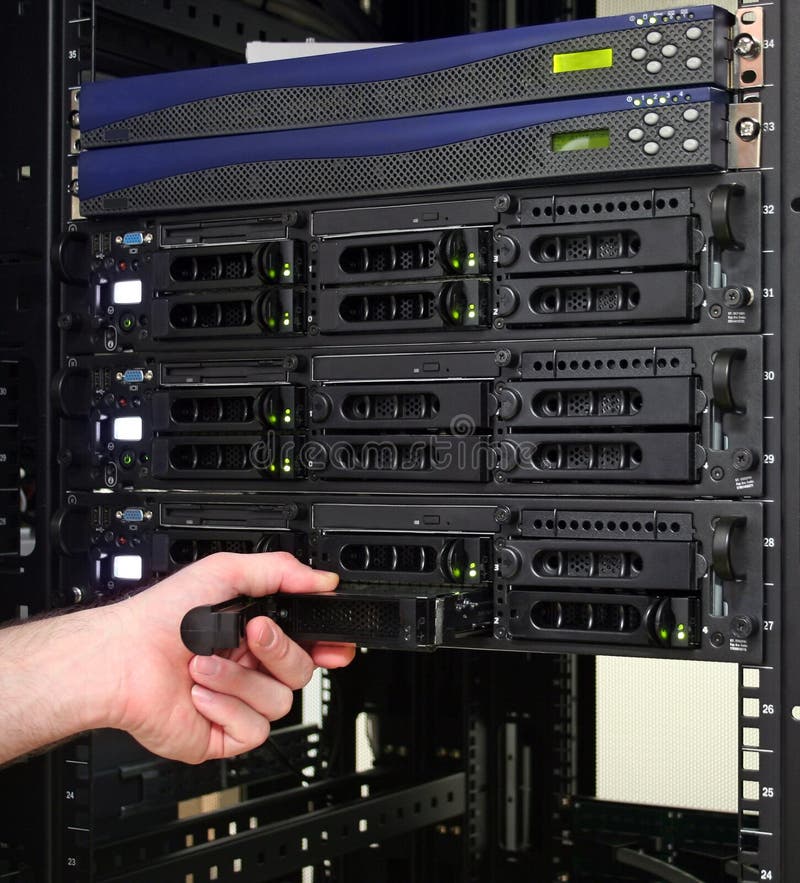 A technician replacing a hot swappable hard drive. A technician replacing a hot swappable hard drive.