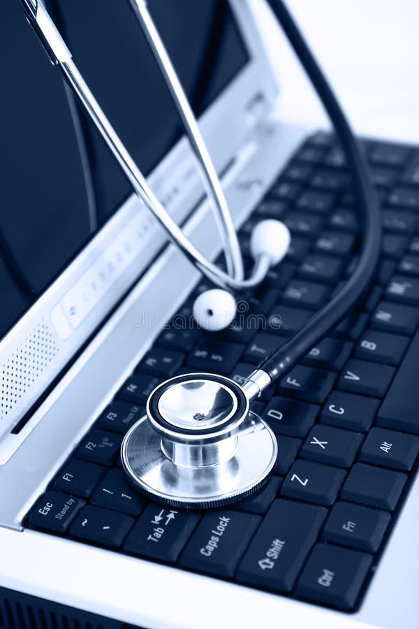 Technology and medicine - Silver stethoscope over laptopkeyboard, blue tint. Technology and medicine - Silver stethoscope over laptopkeyboard, blue tint