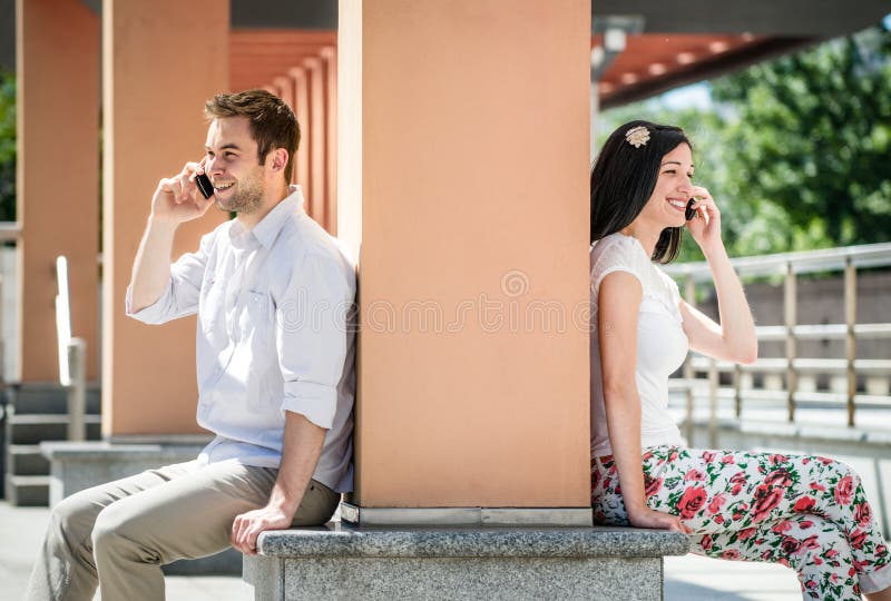 How To Make 2 Phones Call Each Other / Two girls with cell phones stock