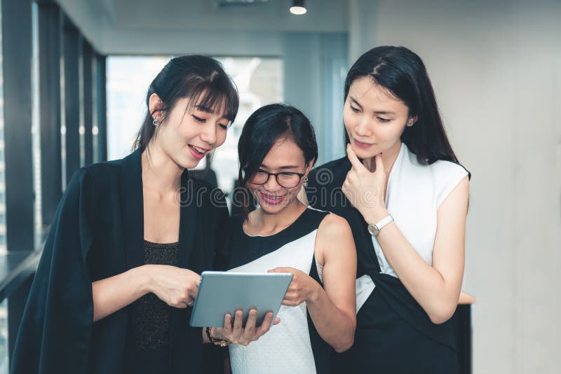 Technology Communication Concept, Group of Young Business People Using Tablet in Conference Room, Business People Talking royalty free stock photo