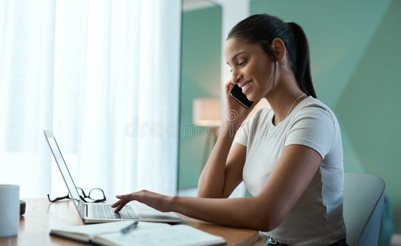 Technology makes life so much easier. a young woman doing paperwork while using a laptop at home. stock photos