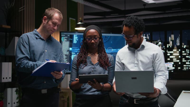 Technology startup coworkers coding in office stock footage