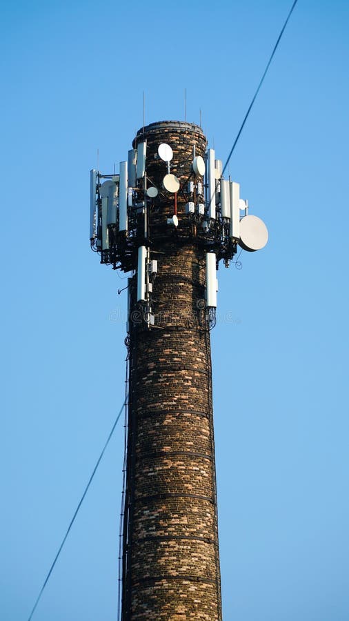 Technology on the top of the telecommunication GSM &#x28;5G,4G,3G&#x29; tower.Cellular phone antennas on a building roof.silhouette of Telecommunication mast television antennas. n. Technology on the top of the telecommunication GSM &#x28;5G,4G,3G&#x29; tower.Cellular phone antennas on a building roof.silhouette of Telecommunication mast television antennas. n