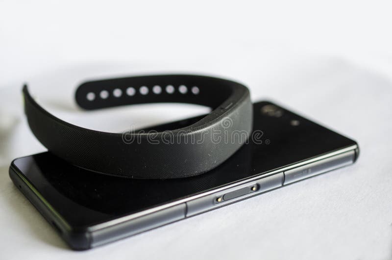 Tecnología usable de la banda elegante con el teléfono móvil imagenes de archivo Tecnología usable de la banda elegante con el teléfono móvil imagenes de archivo