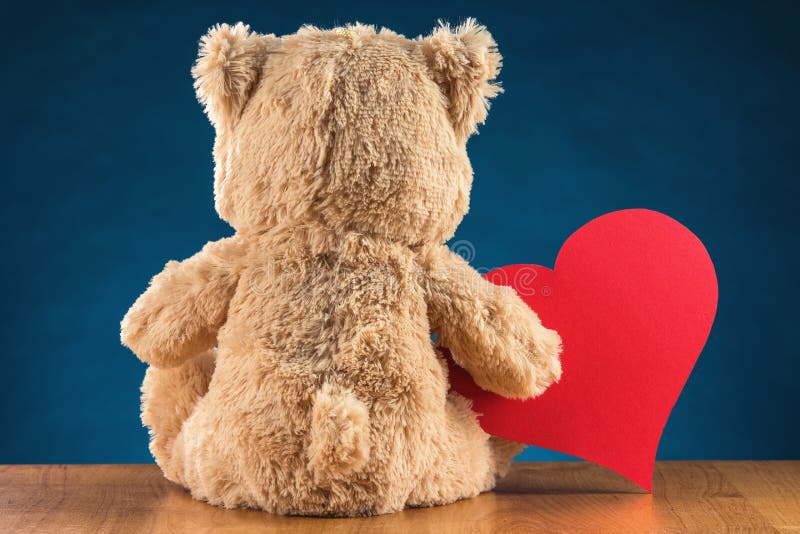 Teddy Bear Holding a Heart stock photo. Image of holding 66412990