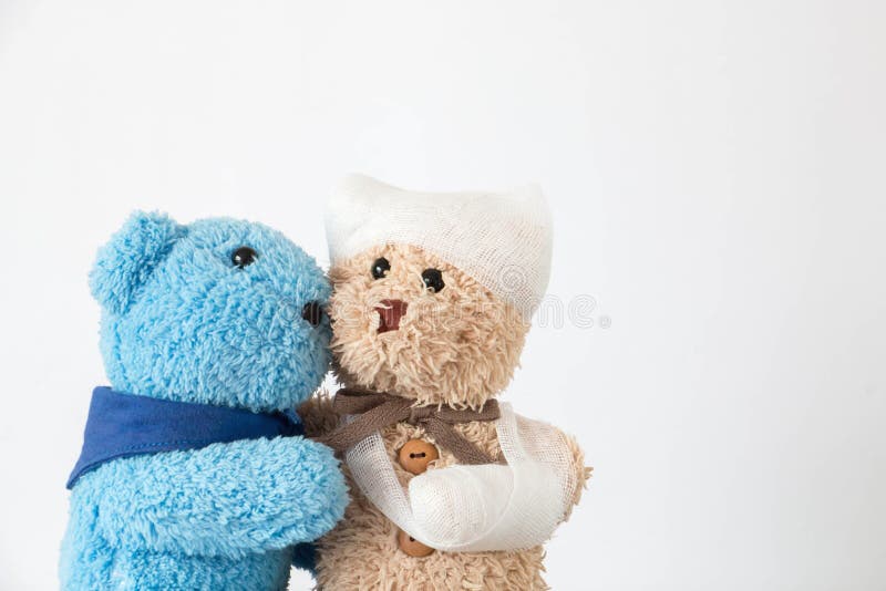 Teddy bear with the trauma of the head and bandages arm and friend take care he.