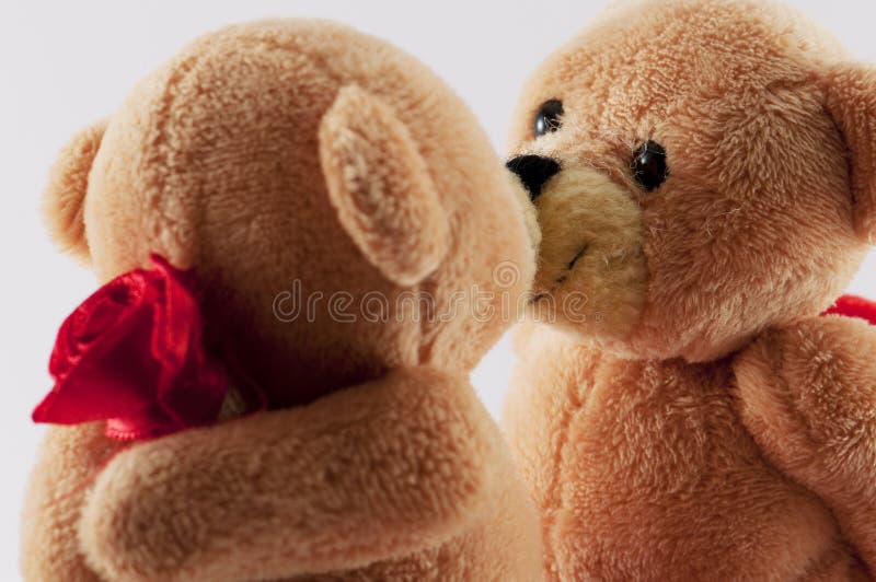 Young woman embracing teddy bear while city in background stock photo