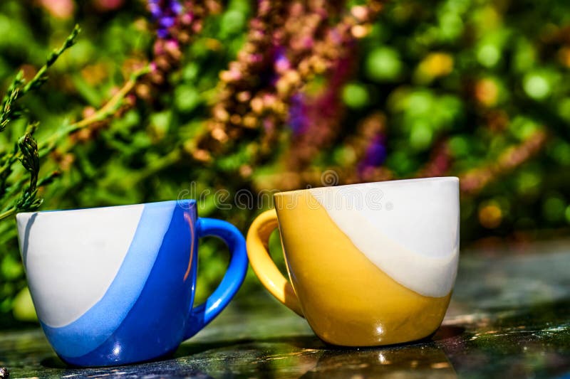 a small bowl shaped container for drinking from, typically having a handle. a small bowl shaped container for drinking from, typically having a handle.