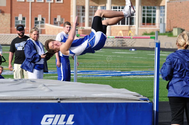 Teen Boy Doing the High Jump at Track Meet stock images
