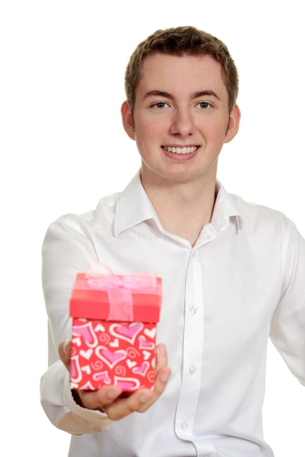 Teen boy giving valentines gift royalty free stock photography Teen boy giving valentines gift royalty free stock photography