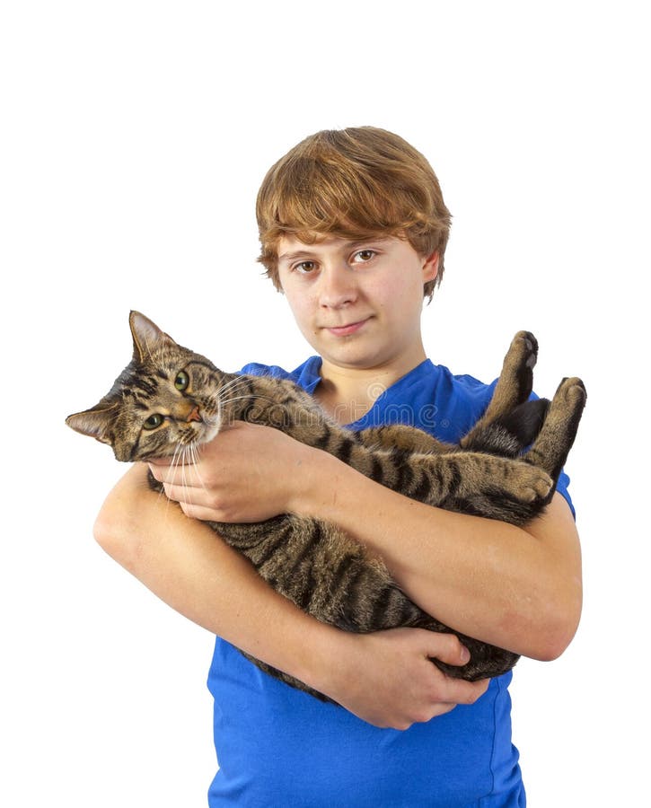 Teen boy holds his tabby cat in his arms