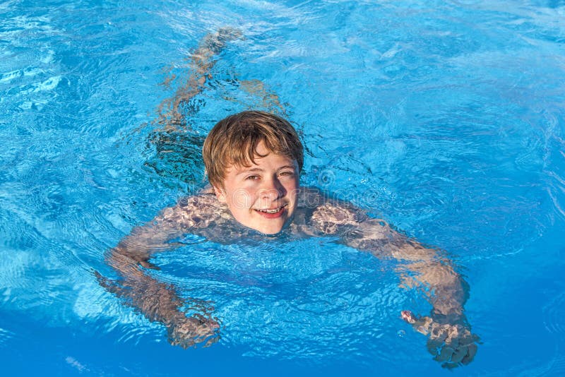 Teen Boy Enjoys Swimming In A Pool Stock Image - Image of 