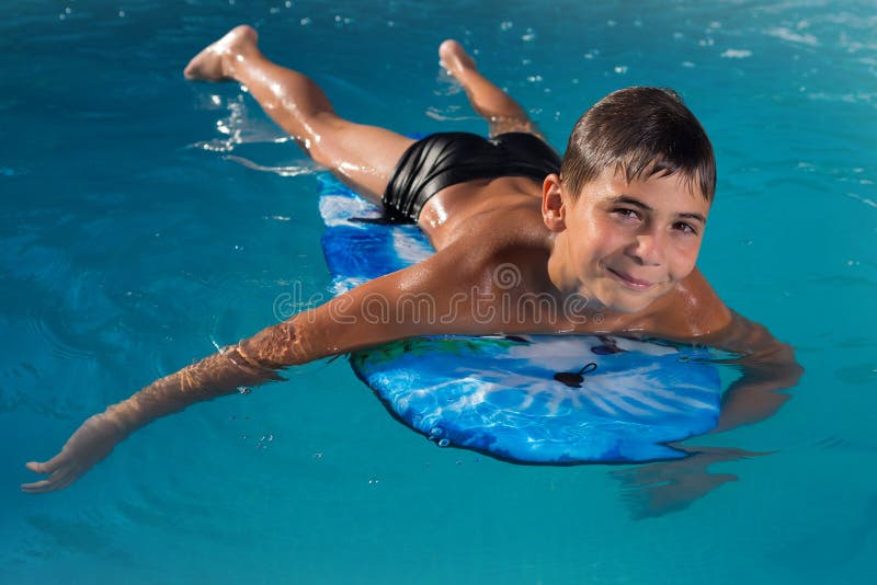 Teen Boy Swimming in the Pool on the ...