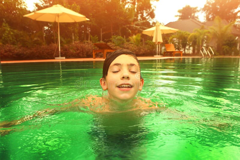 Teen Boy Swimming In A Pool With A Boogie Board Stock 