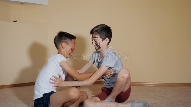 Teen Boys with Hands and Faces in Colorful Paints Sitting on Floor Play with Each Other Stock Footage - Video of cheerful, messy: 133054486