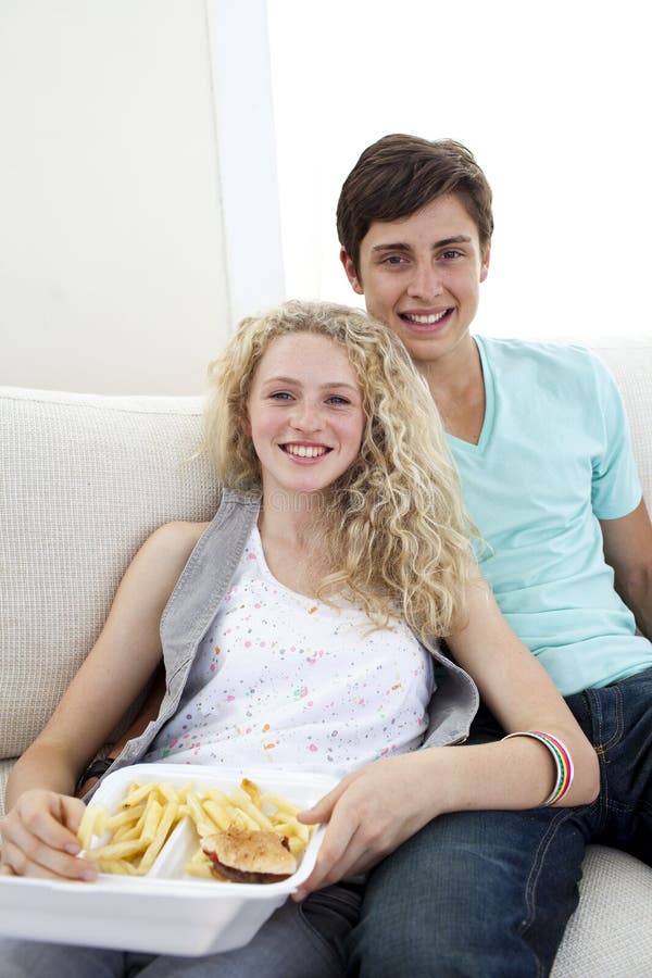 Teen Couple Eating Burgers And Fries Stock Image Im