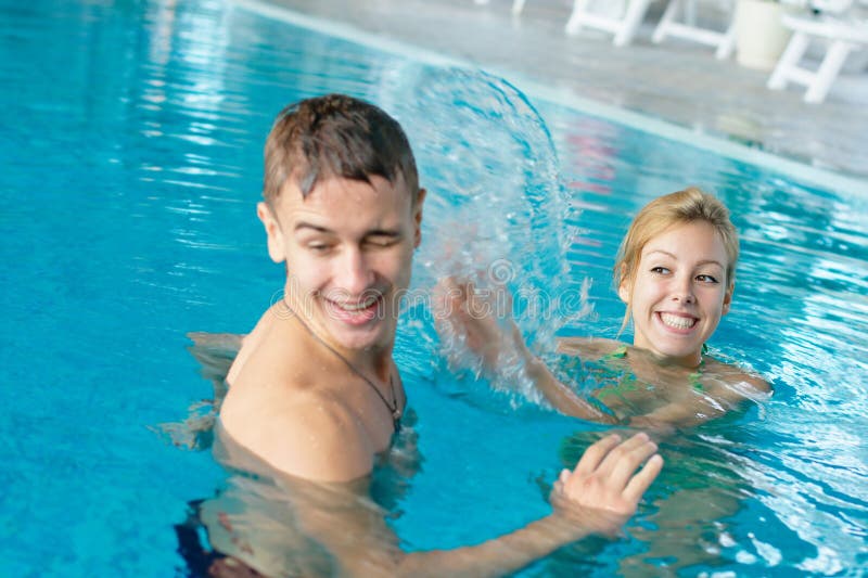 Teen Couple Splashing At The Pool Royalty Free Stoc