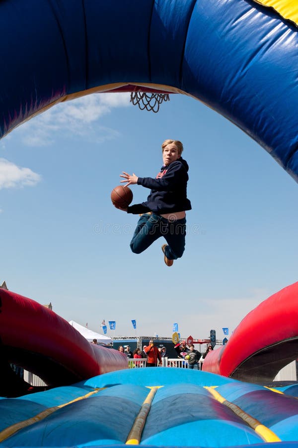 Teen Gets Airborne Attempting To Dunk Basketball Carnival Game Stock ...