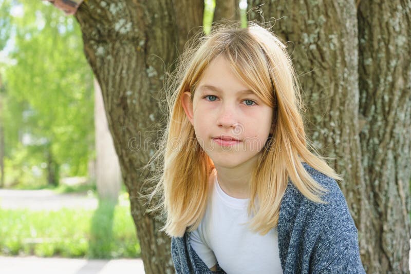 Teen Giel With Blond Hair Near The Tree Summer Nature Stock Photo