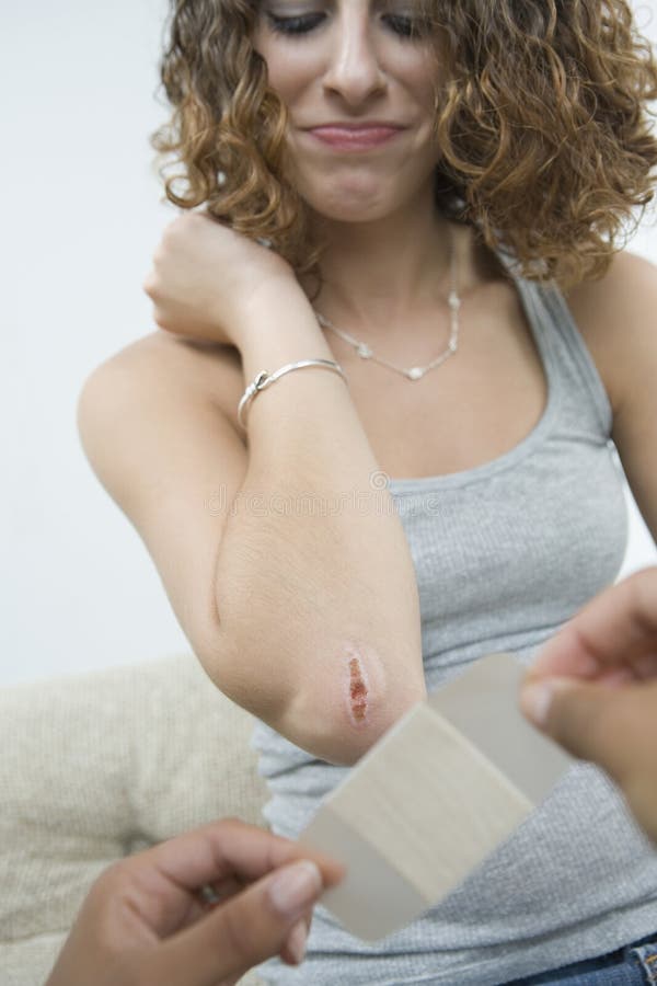 Teen girl being bandaged.